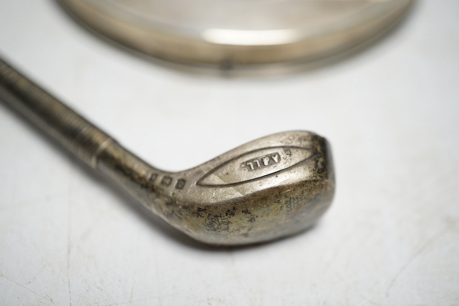 A collection of white metal and hallmarked silver to include three photo frames, a mounted glass flask, a compact, a lipstick holder, a cased pair of Victorian pepper pots, two pairs of Georgian sugar tongs and a mounted